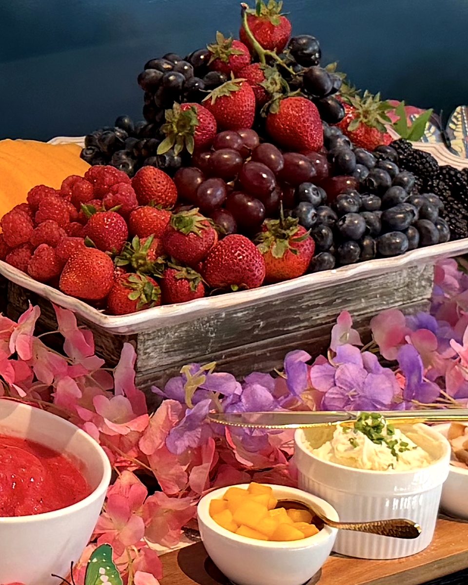 Brunch display of strawberries, grapes, blueberries and blackberries with small dishes alongside